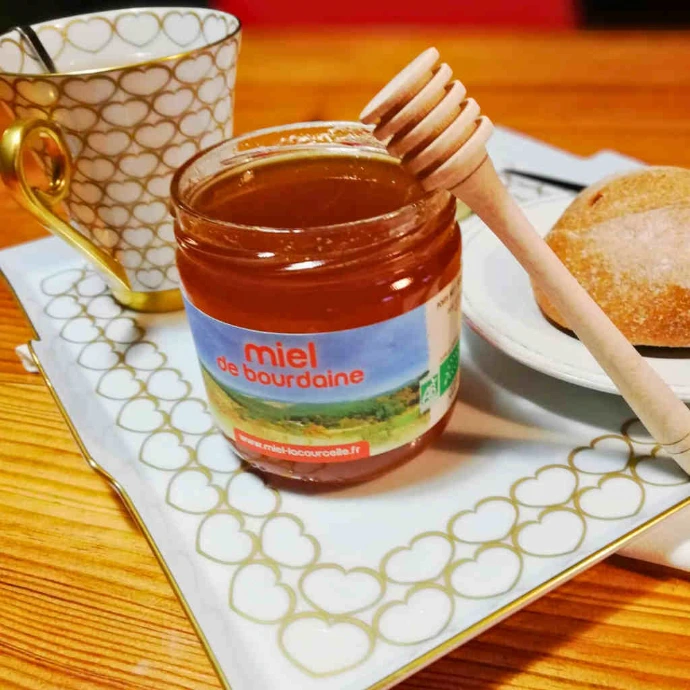 pot de miel de bourdaine bio ouvert tasse de thé et petit pain